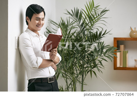Entrepreneur reading thoughts in planner Entrepreneur reading thoughts in planner 72707864
