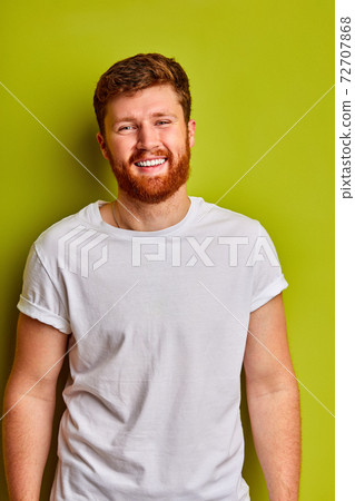 portrait of positive caucasian guy in casual t-shirt smiling at camera 72707868