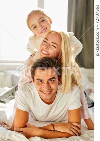 portrait of happy family on bed portrait of happy family on bed 72707963