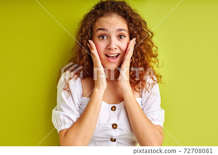 portrait of excited young girl surprised by something, isolated on green background portrait of excited young girl surprised by something, isolated on green background 72708081
