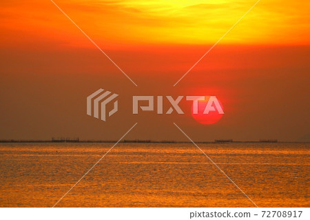 sunset back on the evening dark orange cloud on sky over the sea 72708917