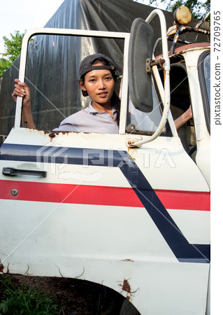 Woman climbs into the truck Woman climbs into the truck 72709765