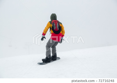 Snowboarding on the slope. Snowboarding on the slope. 72710248