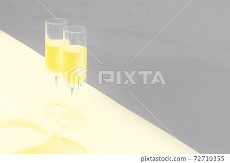 Two glasses of sparkling wine near infinity swimming pool 72710355