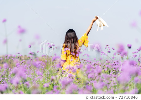 Traveler or tourism Asian women standing and chill  in the purple verbena flower 72710846