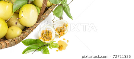 Basket of fresh ripe yellow passion fruit with green leaf, isolated on white background , banner Basket of fresh ripe yellow passion fruit with green leaf, isolated on white background , banner 72711526