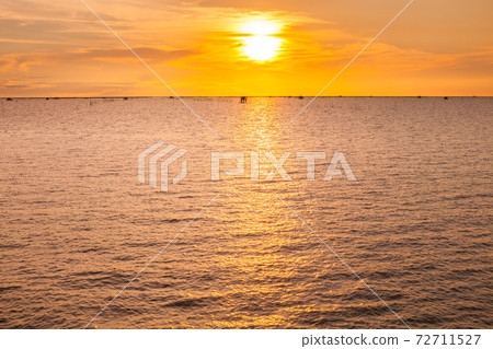 Beach under vivid colorful of sky at sunset timing Beach under vivid colorful of sky at sunset timing 72711527