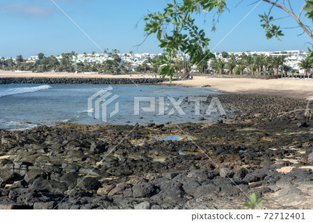 Stones opening during the low tide. Beach in Costa Teguise. Stones opening during the low tide. Beach in Costa Teguise. 72712401