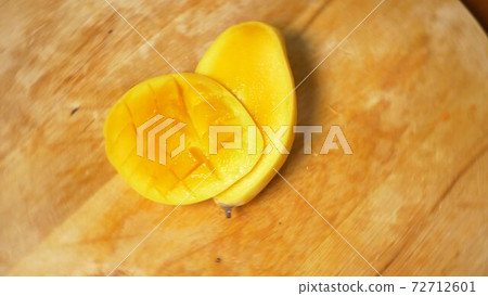 exotic fruits on the table. 4k, mango, passion fruit, fruit cut into pieces, rotate on a cutting 72712601