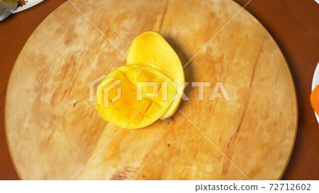 exotic fruits on the table. 4k, mango, passion fruit, fruit cut into pieces, rotate on a cutting exotic fruits on the table. 4k, mango, passion fruit, fruit cut into pieces, rotate on a cutting 72712602