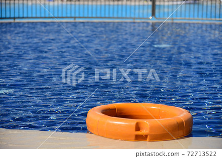 Yellow lifebuoy at the edge of the pool Yellow lifebuoy at the edge of the pool 72713522
