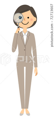 Woman in suit looking through magnifying glass 72713607