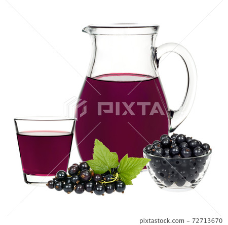 Currant drink in a glass and a decanter with berries currants 72713670