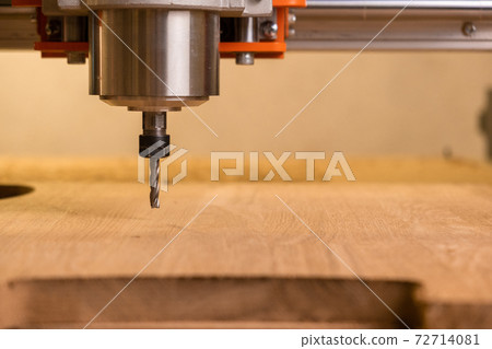 The head of the CNC machine cuts out a wooden decorative thing. The camera follows her. Splinters fly in different directions. extreme close-up The head of the CNC machine cuts out a wooden decorative thing. The camera follows her. Splinters fly in different directions. extreme close-up 72714081
