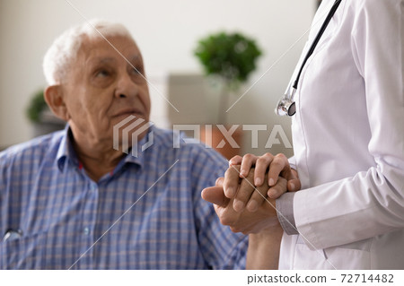 Close up of female nurse support senior male patient Close up of female nurse support senior male patient 72714482