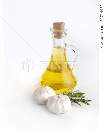 Rosemary twig and garlic, olive oil on bottle isolated on white background. Rosemary twig and garlic, olive oil on bottle isolated on white background. 72714685