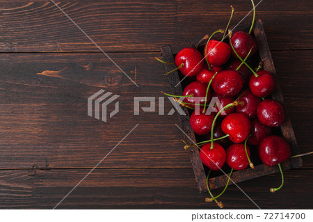 Cherry with leaf on plate and water dropsand on brown stone table Cherry with leaf on plate and water dropsand on brown stone table 72714700