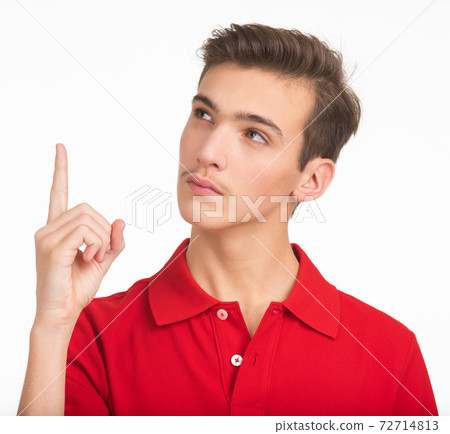 Portrait of thoughtful young man looking up isolated over white background. Photo of pensive white guy in a red shirt. Male person is thinking. Person is thinking looking away. Portrait of thoughtful young man looking up isolated over white background. Photo of pensive white guy in a red shirt. Male person is thinking. Person is thinking looking away. 72714813
