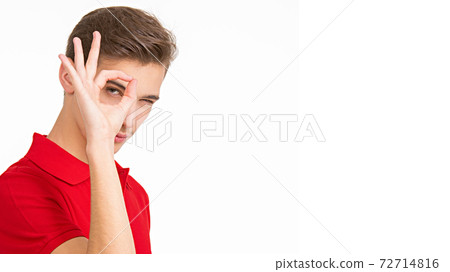 Portrait of happy young man showing okay gesture, isolated over white background. Photo of Handsome white guy in a red shirt with sign OK. Male person shows gesture OKAY . Portrait of happy young man showing okay gesture, isolated over white background. Photo of Handsome white guy in a red shirt with sign OK. Male person shows gesture OKAY . 72714816
