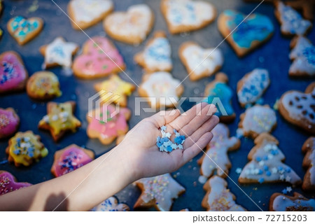 Gingerbread decorations. Christmas gingerbread cookies with tasty colorful sugar. 72715203
