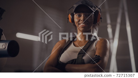 Professional black woman working on metal cutting equipment 72715307