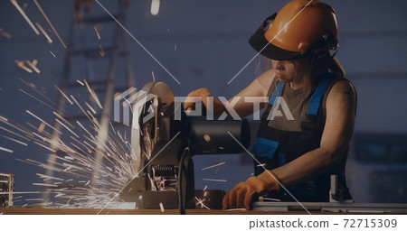 Female worker working with metal cutting saw Female worker working with metal cutting saw 72715309