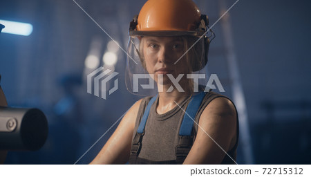 Professional woman in hardhat on factory production Professional woman in hardhat on factory production 72715312