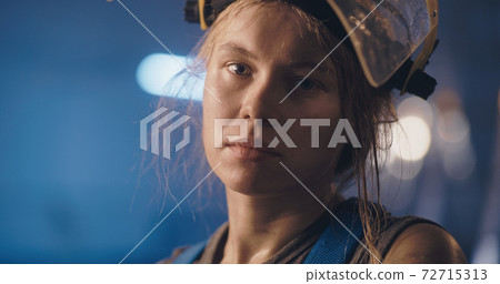 Exhausted female worker of factory after long workday Exhausted female worker of factory after long workday 72715313