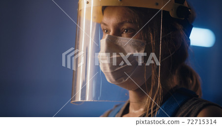 Exhausted female worker of factory after long workday Exhausted female worker of factory after long workday 72715314