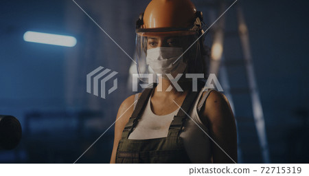 Tired black woman taking hardhat after long workday Tired black woman taking hardhat after long workday 72715319