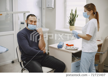 Nurse taking blood sample from patient at the doctors office Nurse taking blood sample from patient at the doctors office 72715407