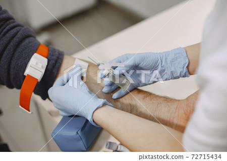 Nurse taking blood sample from patient at the doctors office 72715434