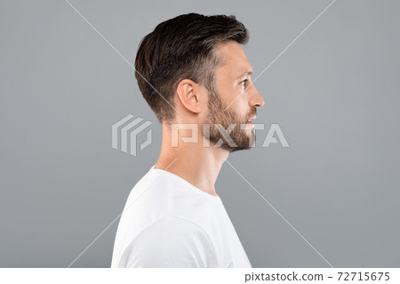 Profile portrait of middle-aged man over grey background Profile portrait of middle-aged man over grey background 72715675