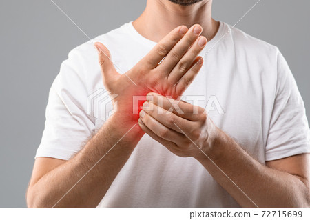 Unrecognizable man scratching itch on his hand 72715699