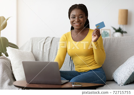 Online Payment. Black Female Holding Credit Card And Using Laptop At Home Online Payment. Black Female Holding Credit Card And Using Laptop At Home 72715755
