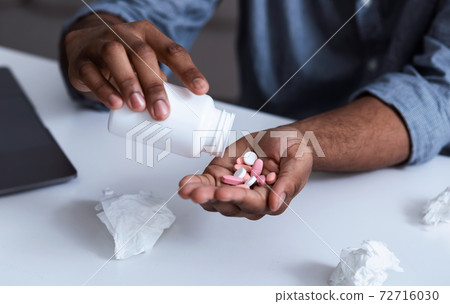 Closeup Of Medical Pills In Black Man's Hand, Cropped 72716030