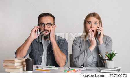 Frightened and shocked man with beard and glasses and with open mouths in workplace Frightened and shocked man with beard and glasses and with open mouths in workplace 72716070