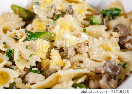 Farfalle pasta with champignon mushrooms asparagus and garlic creamy sauce Farfalle pasta with champignon mushrooms asparagus and garlic creamy sauce 72716338