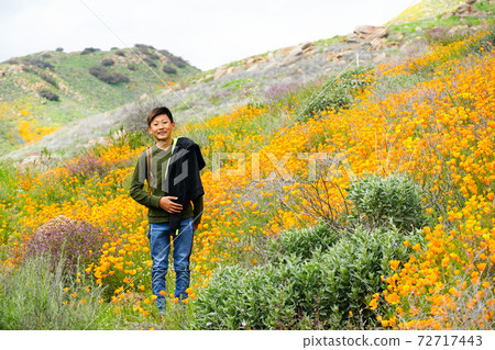Young sporty Asian boy enjoying and hiking the mountain during the California Golden Poppy Young sporty Asian boy enjoying and hiking the mountain during the California Golden Poppy 72717443