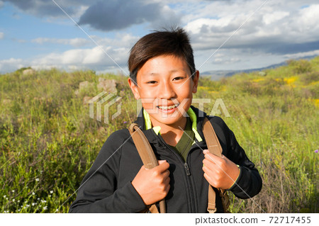 Young sporty Asian boy enjoying and hiking the mountain during the California Golden Poppy  72717455