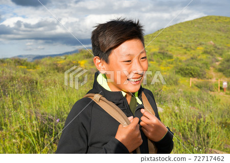 Young sporty Asian boy enjoying and hiking the mountain during the California Golden Poppy  72717462