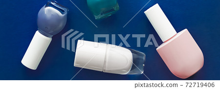 Nail polish bottles on dark blue background, beauty brand 72719406