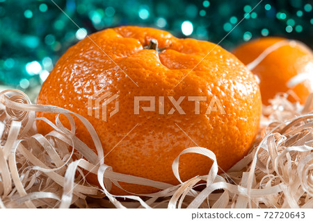 Ripe orange tangerine on a bright blurry background 72720643