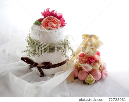 Handmade clay cake and macaron tower on white cloth 72722981