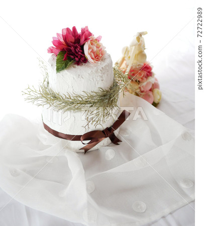 Handmade clay cake and macaron tower on white cloth 72722989