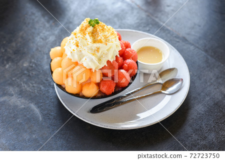 Bingsu dessert, fruit bingsu cantaloupe and watermelon with milk cream menu eat cooling sweet iced served on the table Korea food. 72723750