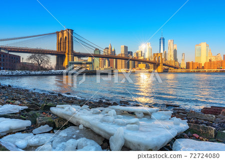 Brooklyn bridge and Manhattan at winter sunrise Brooklyn bridge and Manhattan at winter sunrise 72724080