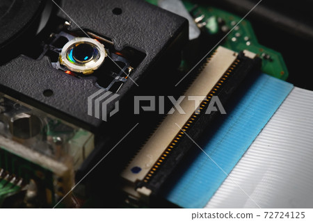 Close-up of a laser lens for reading and writing dvd rom flat cable cd drive. Readout optical design 72724125