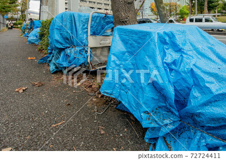 Homeless luggage on the sidewalk 72724411