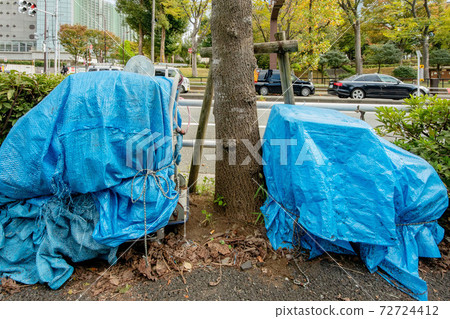 Homeless luggage on the sidewalk 72724412